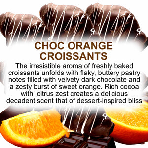 Choc orange croissants with chocolate drizzle and orange slices on a white background